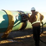 technician-inspecting-pipeline